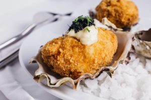close-up-deep-fried-oysters-topping-with-mayonnaise-caviar-served-white-plate-new